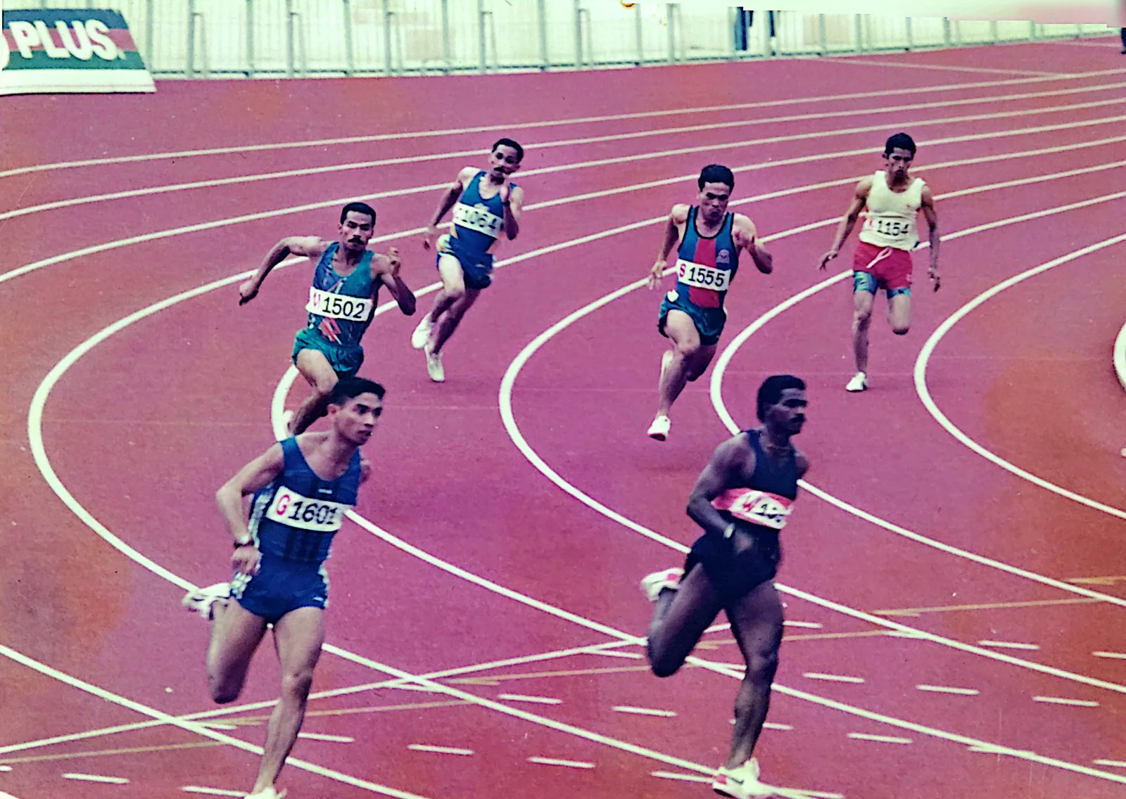 Sprinters coming off the bend at a meet in Malaysia, from the coach's own album of his racing years