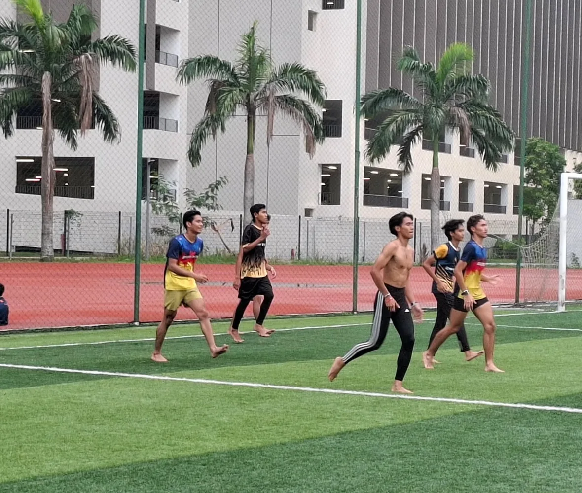 The squad running together across the field