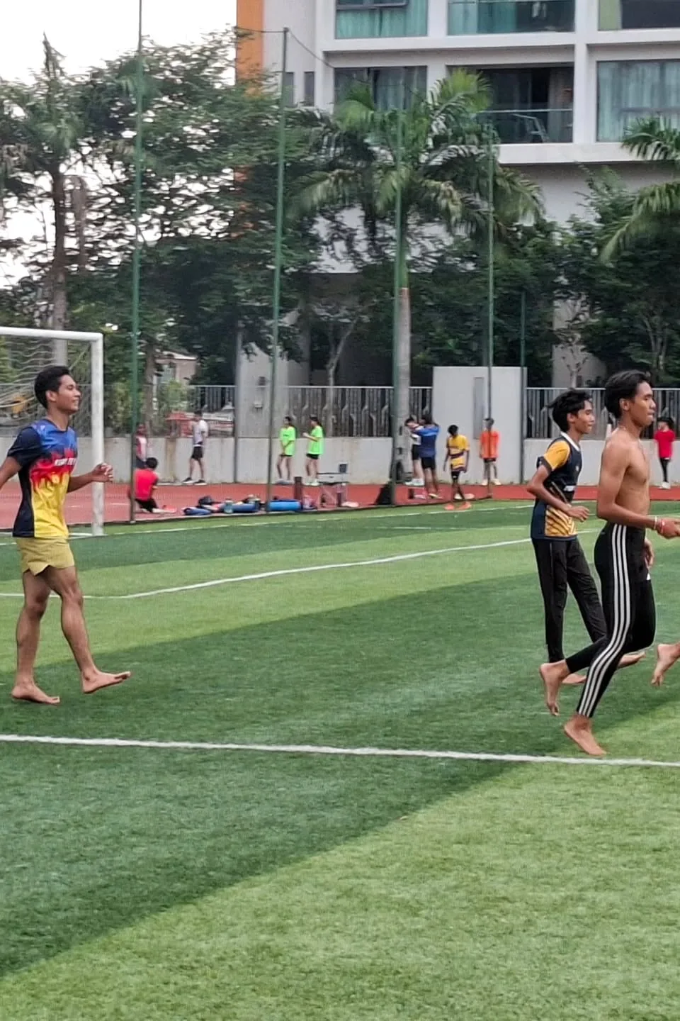 Athletes running at speed across the field during a session